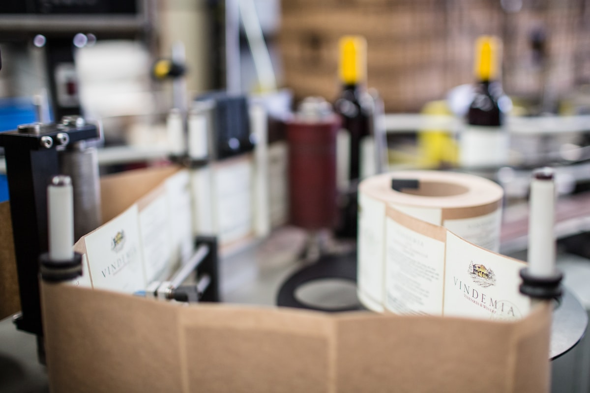 Rolls of finished printed labels loaded on a labelling machine, liner web feeding through
