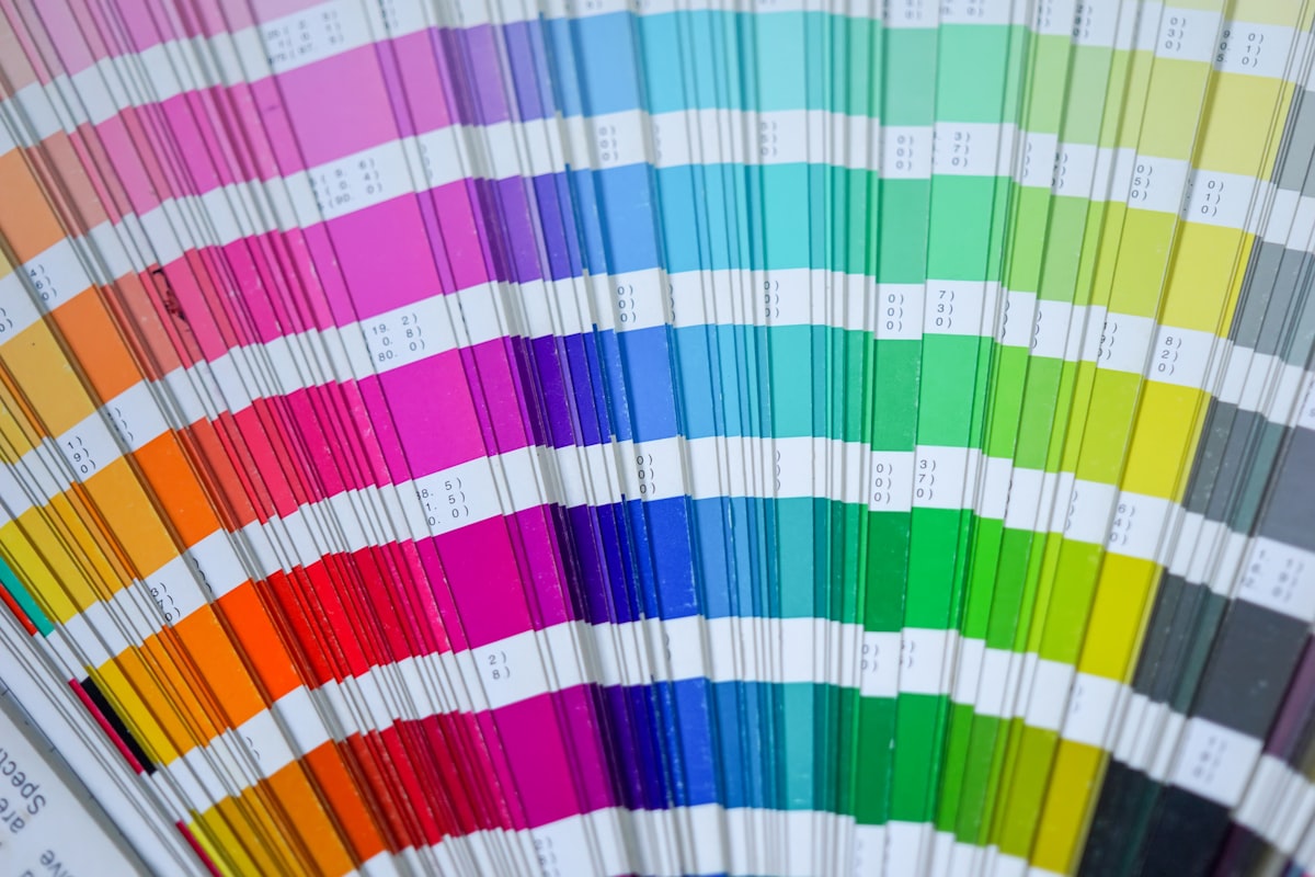 A Pantone swatch book fanned open across numbered spot-colour chips