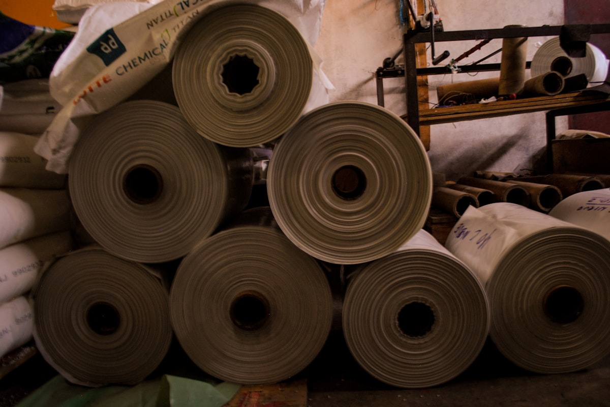 Rolls of paper and film label substrate stacked on cores in a converting plant